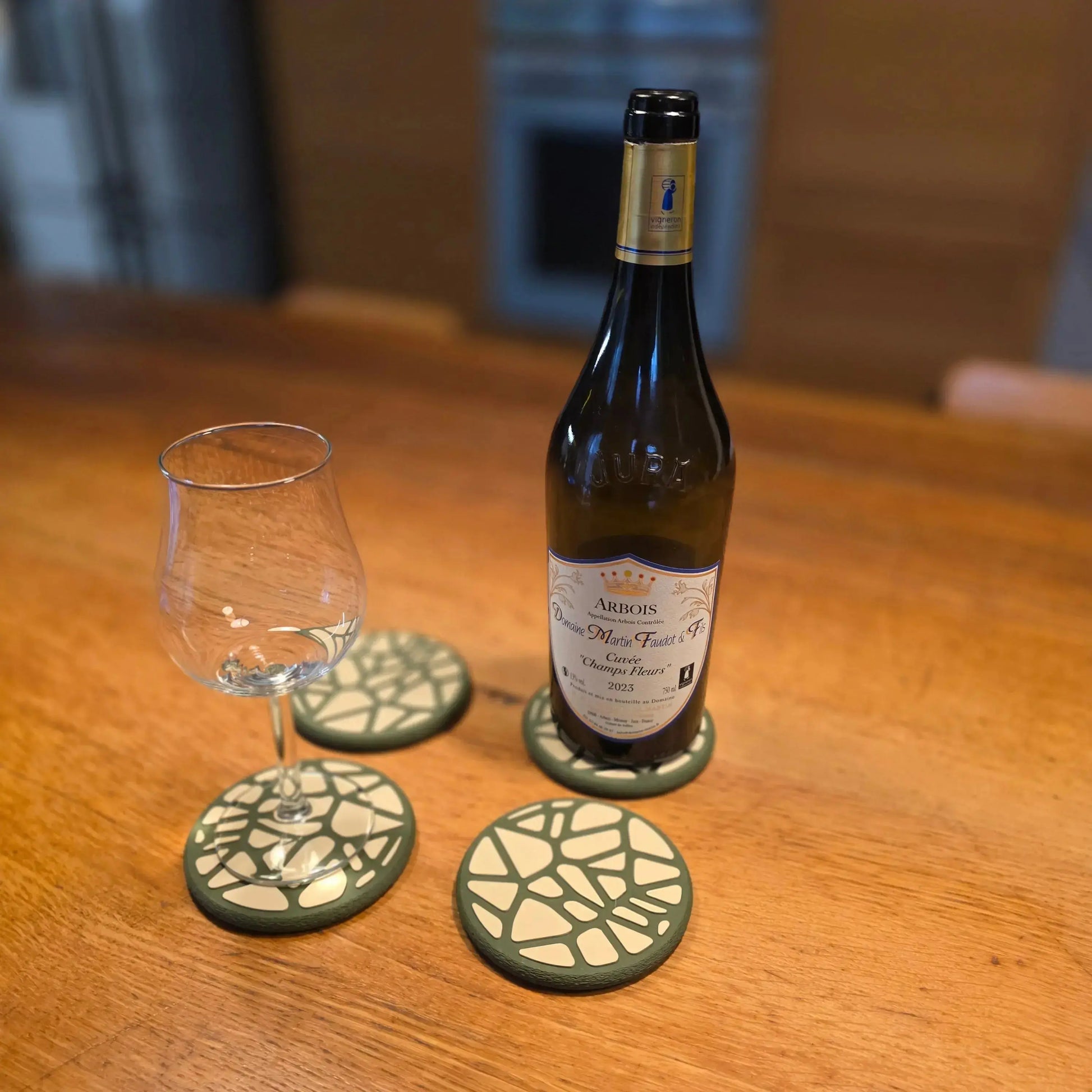 Un verre d'eau posé sur un dessous de verre design Voronoi , protégeant une surface de table moderne.